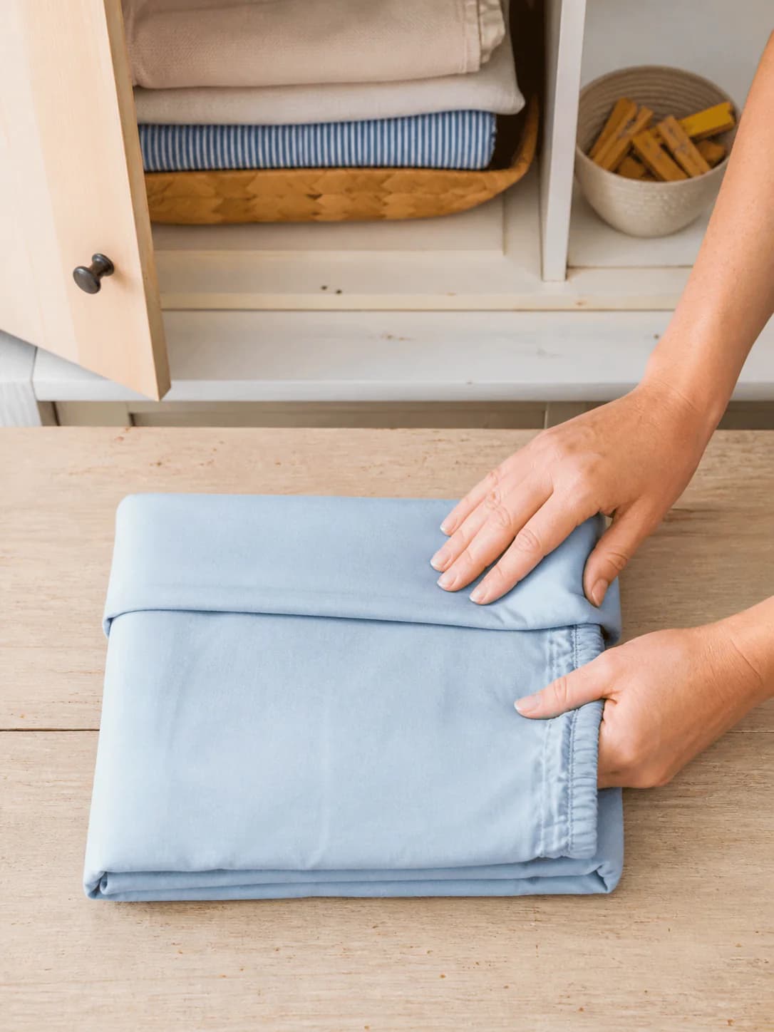A fitted sheet folded into a flat square after pressing