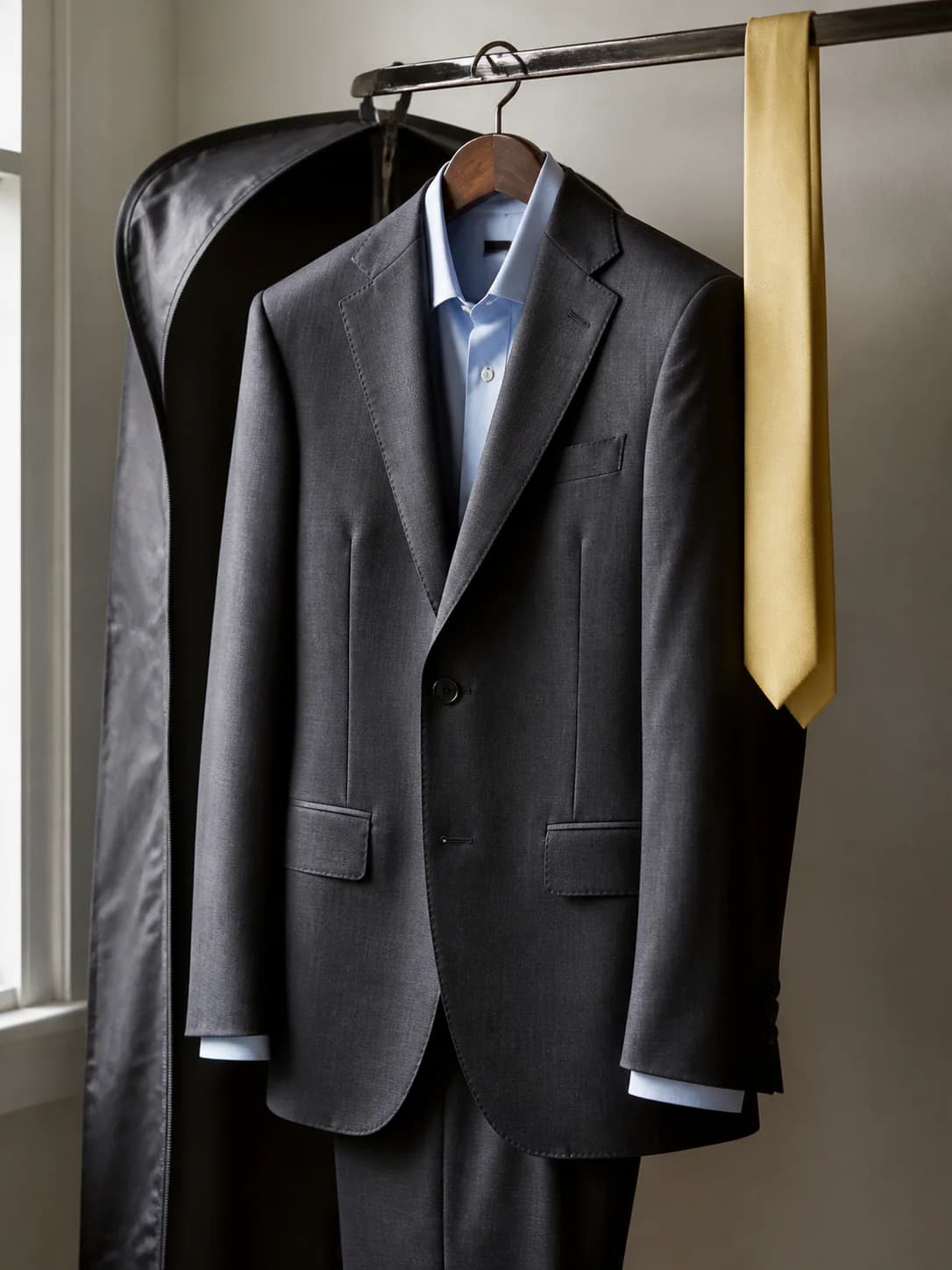 A pressed interview suit hanging ready for delivery
