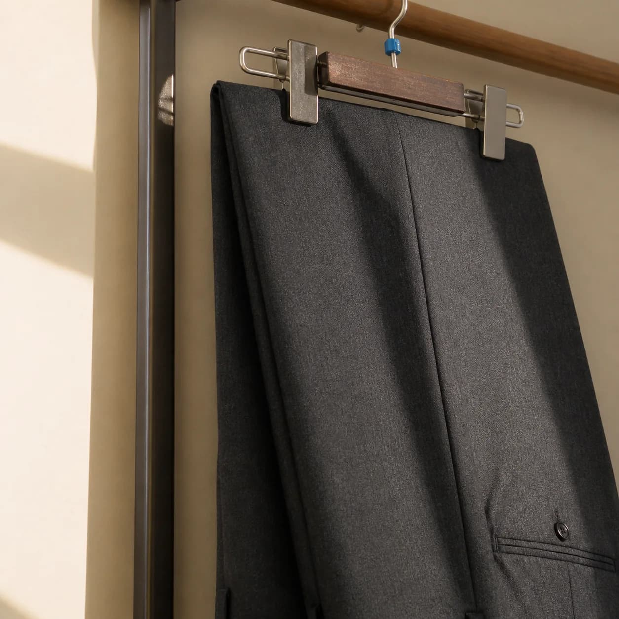 Pressed trousers hung with a sharp crease down the leg