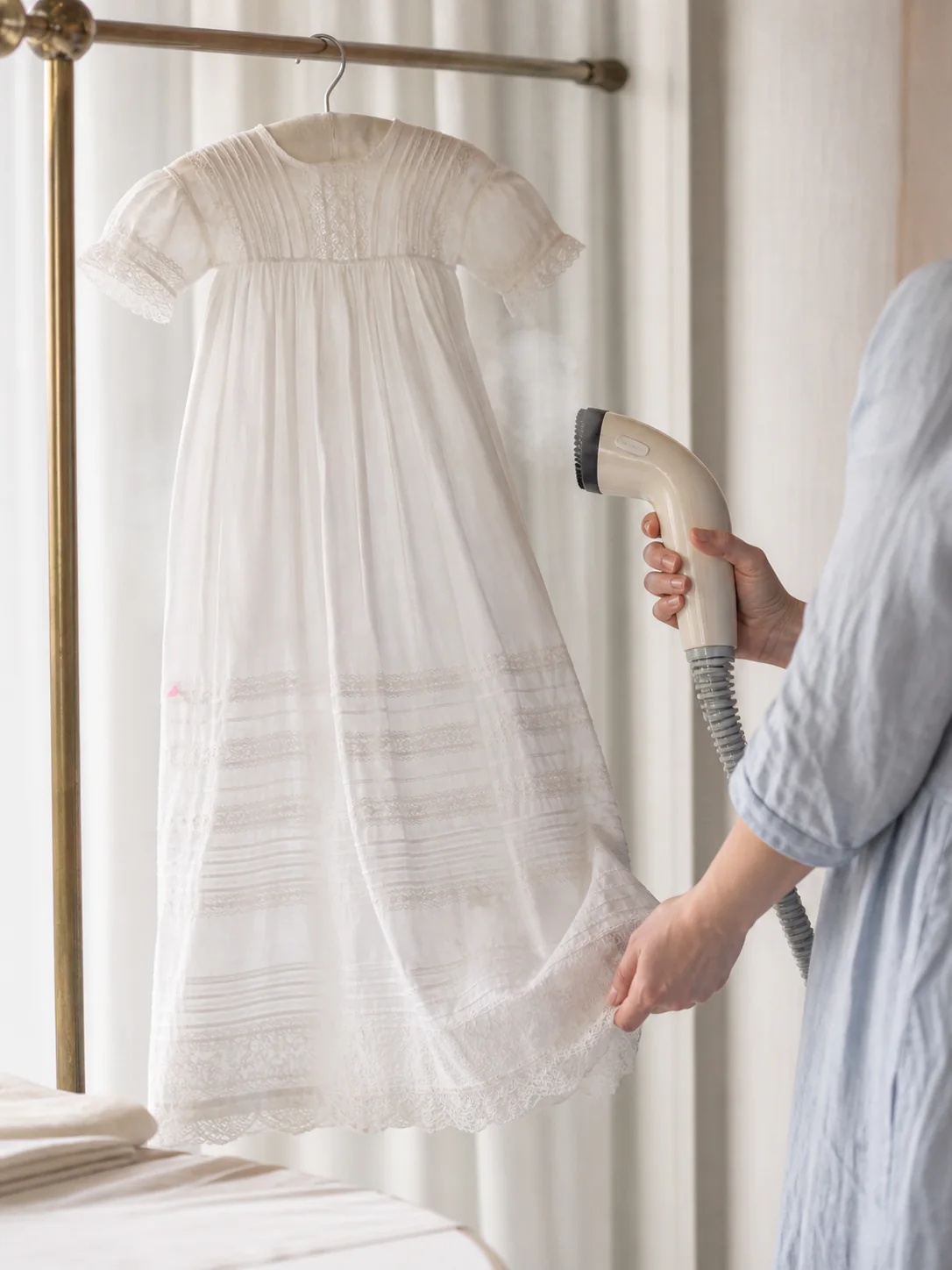 A christening gown steamed by hand with no direct iron contact
